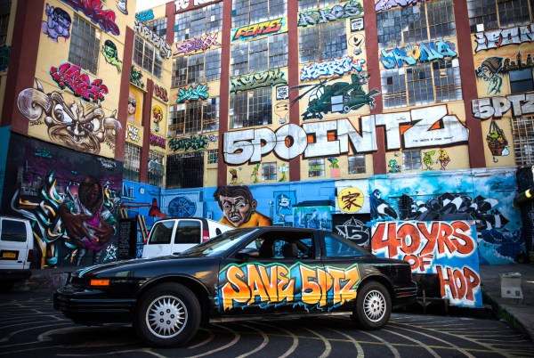 NEW YORK, NY - OCTOBER 28: A graffiti painted car is parked in front of the 5 Pointz Building, a landmark in the New York graffiti scene that has attracted artists from around the globe, on October 28, 2013 in the Long Island City neighborhood of the Queens borough of New York City. The artists that have been using 5 Pointz to paint for the past two decades are currently in a battle with the building's owners, who want to tear the building down to build apartment high rises worth $400 million. The 5 Pointz artistic community have also called on street artist Banksy who is currently in the midst of a high profile "month in residence" series, creating work through out the streets of New York, to weigh in on the battle, though so far the artist has stayed silent. Meres One says he is prepared to chain himself to the building, should demolition move forward. (Photo by Andrew Burton/Getty Images)